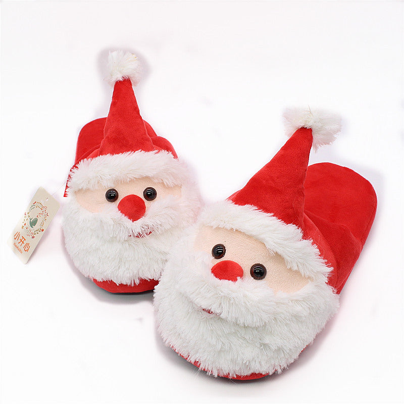 Pair of Santa Claus slippers with red hats and white beards on a white background