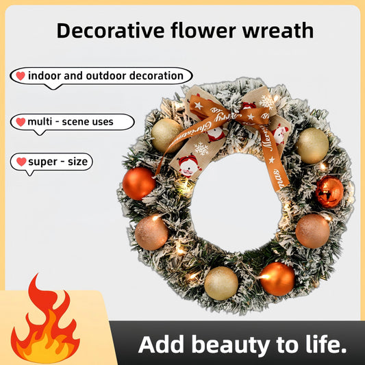 Decorative flower wreath with lights and ornaments on a light gray background